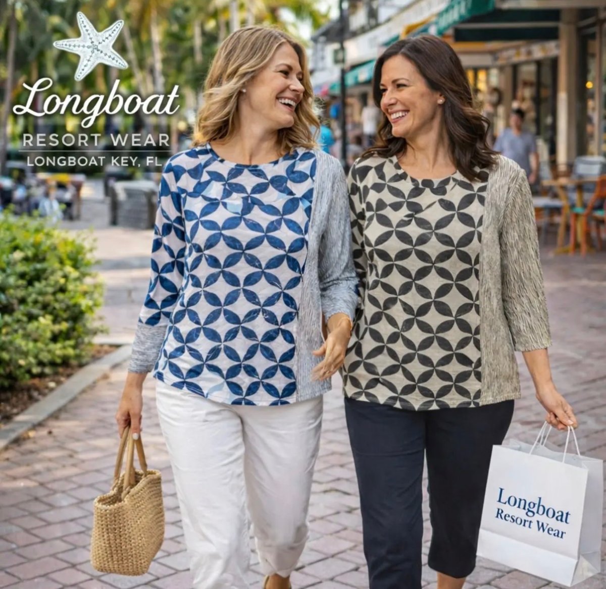 Two women in coordinating blue and tan geometric-print resort tops walking on Longboat Key carrying a Longboat Resort Wear shopping bag